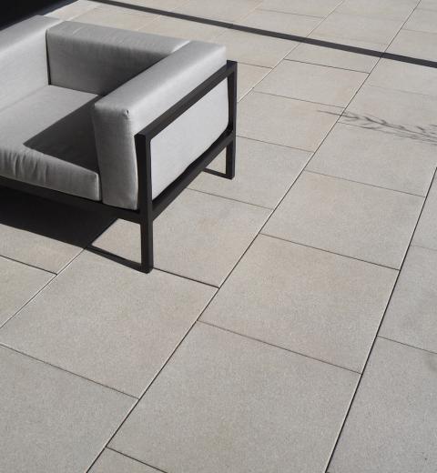 Moderne, edle Terrasse mit großen Bodenplatten, die Dünne quadratisch, in Creme-Beige gestrahlt, sanft weich strukturiert von BK